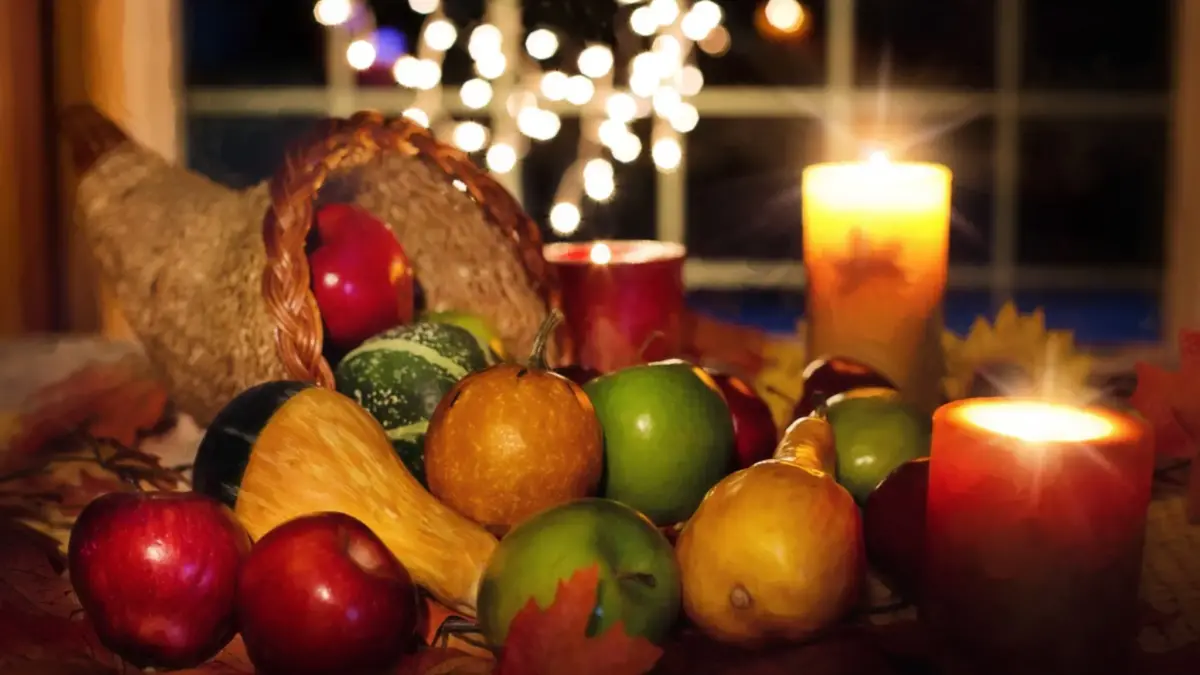 Thanksgiving cornucopia and candles on table