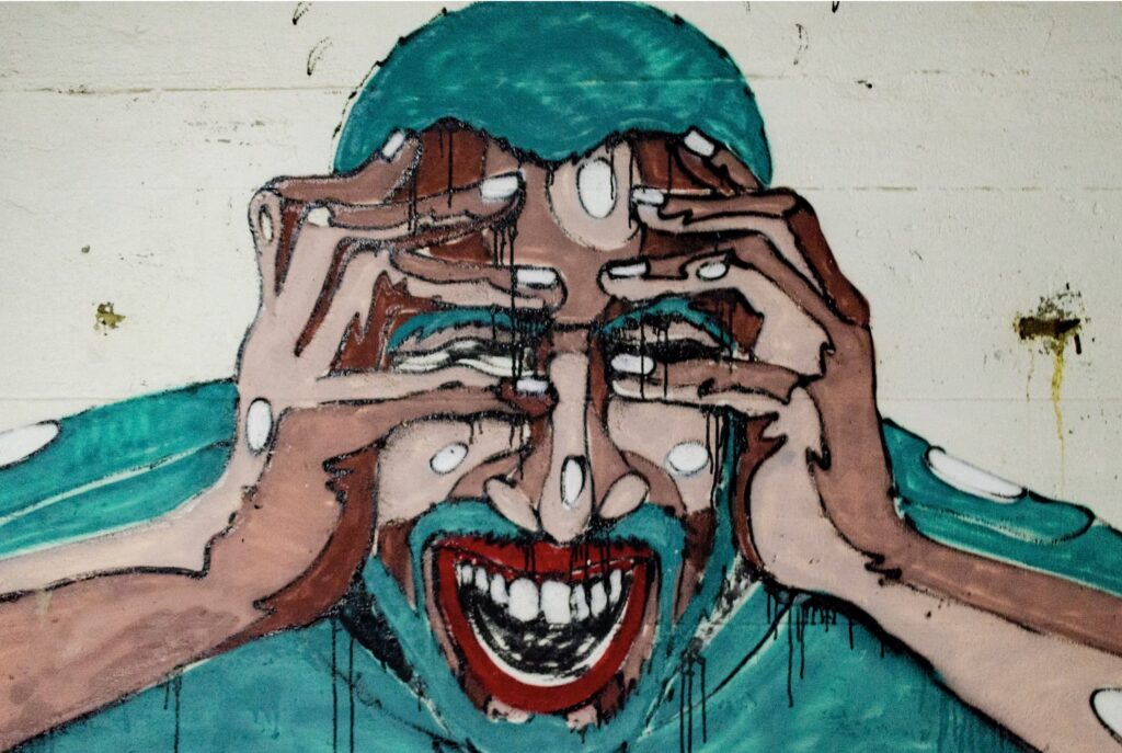 Colorful mural of a laughing face