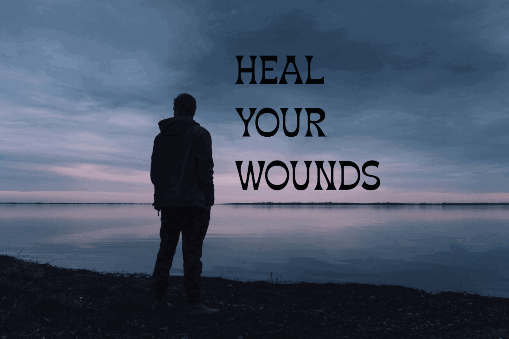Silhouette by lake with quote: Heal Your Wounds.