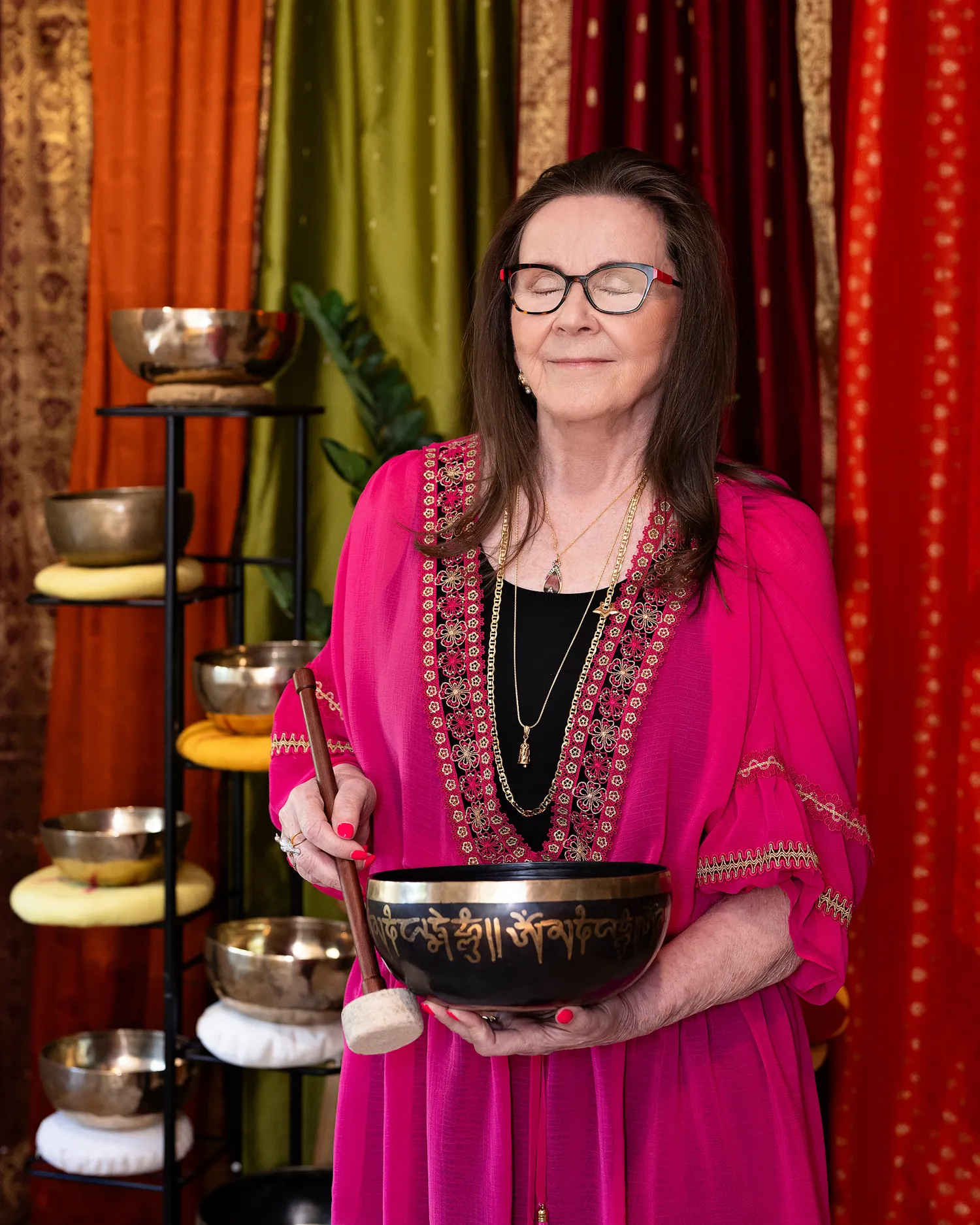 Dorothy Tannahill-Moran in meditation, eyes closed, holding a Tibetan singing bowl