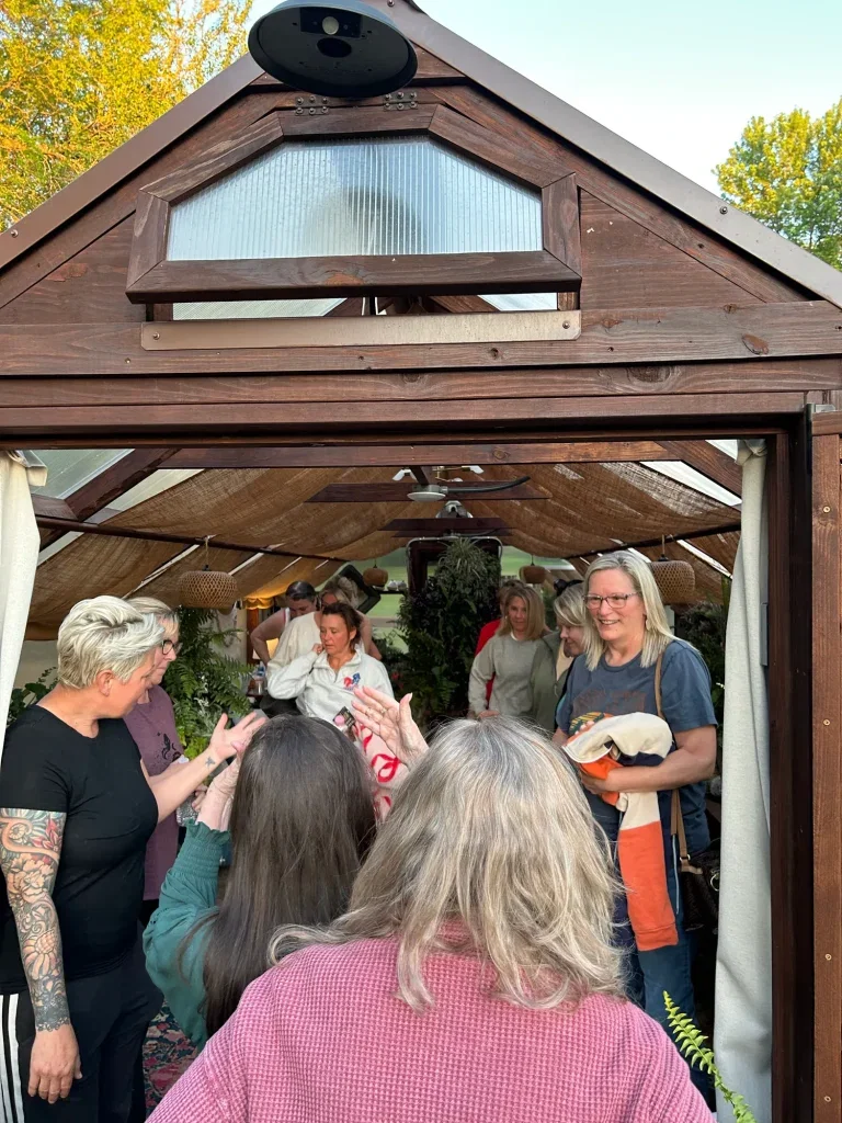 Welcoming hugs as guests arrive for a women's wellness event